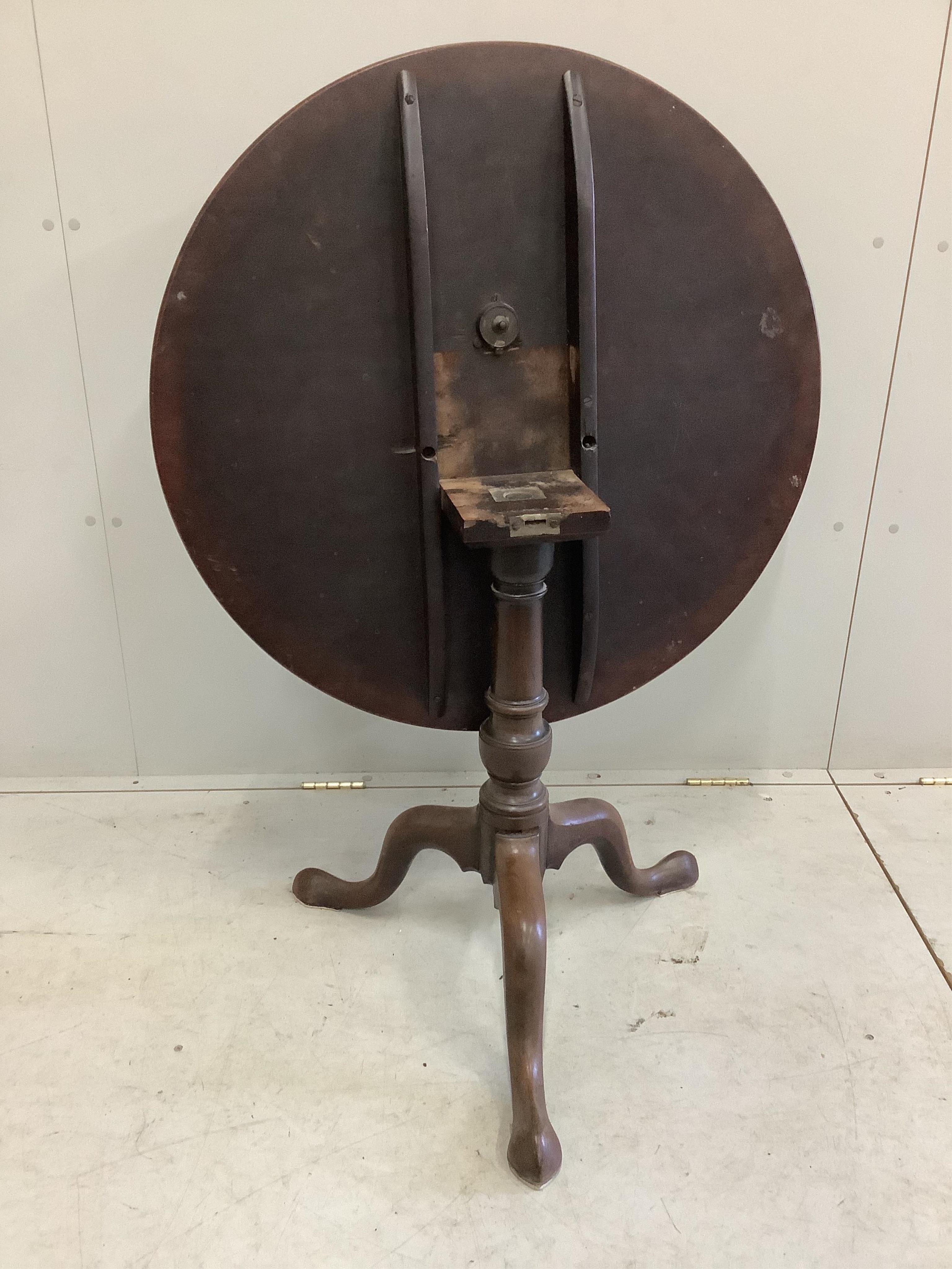 A George III mahogany circular tilt top tea table, diameter 80cm, height 68cm. Condition - poor to fair